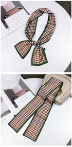Classic houndstooth twilly silk scarf tied on beige handbag with green border detail