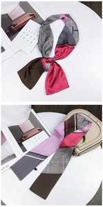 Close-up of a double-sided floral and houndstooth silk twilly scarf with geometric patterns
