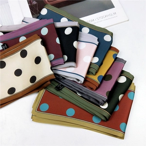 Polka dot satin silk scarves in multiple colors arranged in a decorative fan display