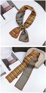 Detail of silk scarf with yellow plaid and houndstooth patterns on a stylish handbag