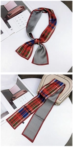 Detail of slim silk scarf featuring red-green plaid and black-white houndstooth patterns