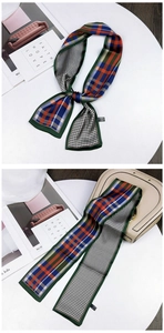 Detail of floral plaid scarf showing houndstooth patterns tied on a beige handbag