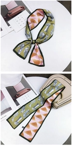 Detail of animal print silk scarf tied on a handbag with double-sided geometric pattern