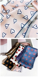 Detail of silk-feel long neckerchiefs with hand-drawn heart patterns in various colors