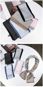 Close-up of assorted vertical striped silk-like polyester skinny scarves in multiple colors