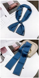 Detail of navy blue satin skinny scarf showing smooth texture and herringbone edges
