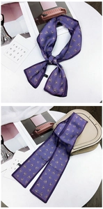 Close-up of purple heart pattern silk twilly scarf tied on a beige handbag handle