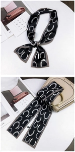 Detail of animal pattern silk twilly scarf wrapped on handbag handle with knot style