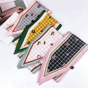 Detail of assorted plaid and leopard print narrow scarves for bags or hair styling