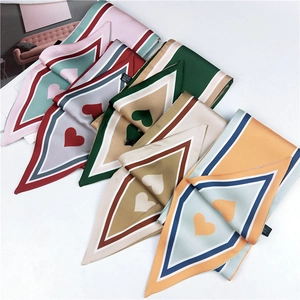 Detailed flat lay of multi-colored polyester scarves with heart and geometric patterns