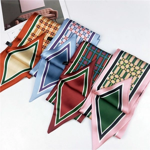 Detail of four colorful geometric plaid satin scarves in polyester with 100% label