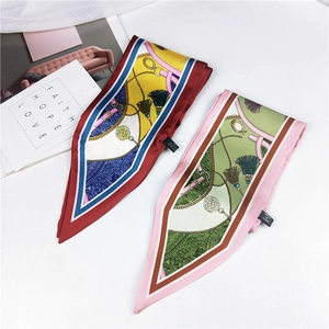 Close-up of printed silk-feel scarves with equestrian motifs and paisley patterns