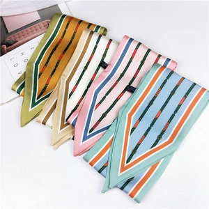 Detail view of four patterned polyester scarves with stripe and belt buckle prints