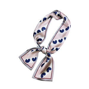 Pink and white striped narrow silk scarf with blue heart patterns in a knotted style