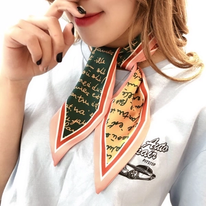 Close-up of a vintage green and yellow Twilly silk scarf tied around a model's neck