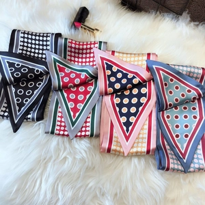 Chic polka dot skinny silk scarves in four assorted colors on soft faux fur background