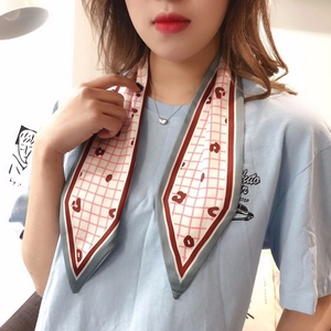 Detail of red and white checkered neck scarf with heart patterns and blue borders