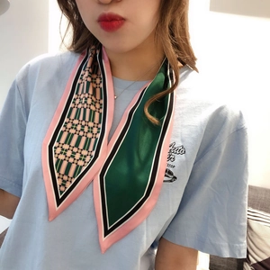 Close-up of a pink and green color-block Twilly silk scarf with classic plaid patterns
