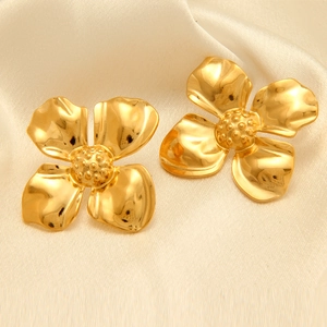 Dettaglio di orecchini a fiore placcati in oro 18k con petali e cuore a trama realistica