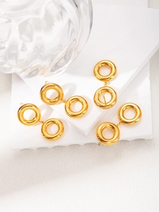 Detailed view of gold-plated geometric double hoop earrings on a marble display stand