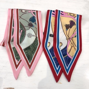 Detail of 100% polyester twilly scarves featuring vintage equestrian prints and tassels