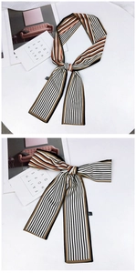 Détail d'un foulard en soie rayé avec motif orange et noir noué avec élégance