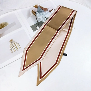 Detail of elegant pointed champagne gold silk scarf draped over a fashion magazine