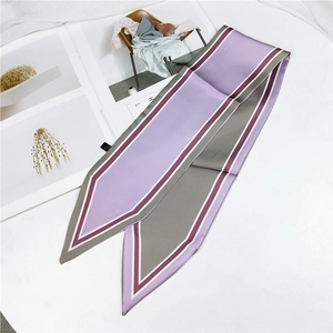 Detail of lavender and dark grey twilly scarf with elegant striped edges on magazine