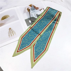 Detailed view of sage green satin skinny scarf with dot pattern and striped ends