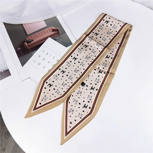 Close-up of elegant beige polka dot silk twilly scarf with dog motifs and contrast edges