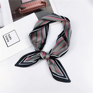Detail of colorful striped silk scarf with zig-zag patterns tied in a stylish bow