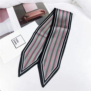 Detail of striped silk-like scarf with pointed ends featuring modern geometric patterns
