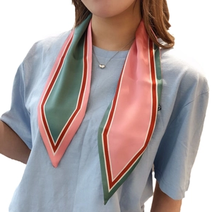 Chic color-block twilly silk scarf in pink and green tied on neck for a stylish look