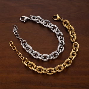 Chunky mixed texture chain bracelets in gold and silver steel on dark wood surface