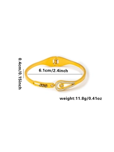 Detail of gold teardrop bangle with pavé crystals showing 0.4cm width and 6.1cm diameter