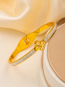 Macro detail of 18k gold plated stainless steel clover bangle with diamond inlay