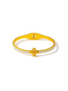 Detailed macro view of 18k gold plated clover bracelet with sparkling pavé zircons