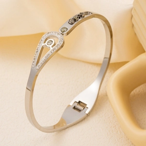 Polished stainless steel bangle with teardrop hollow and sparkling pavé crystals