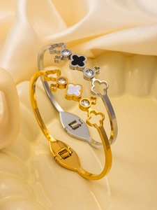 Macro view of clover bangle with white shell inlay and sparkling zircon detailing