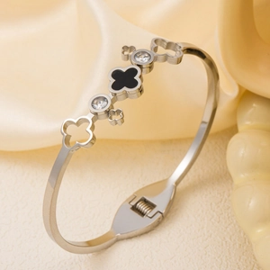 Silver stainless steel open bangle with black clover and hollow clover design elements