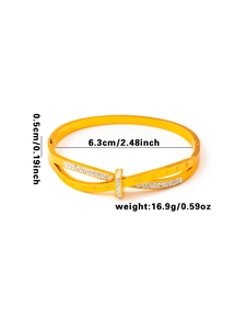 Détail d'un bracelet doré avec chiffres romains gravés et double rangée de cristaux