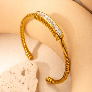 Elegant gold-tone braided cuff bracelet with a sparkling crystal-encrusted center bar