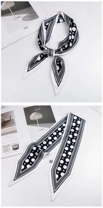 Detailed pattern of black and white polka dot skinny scarf with pointed ends and mesh lines