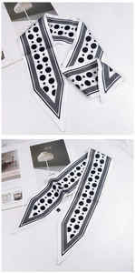 Macro detail of silk scarf featuring bold polka dots and geometric diamond line edges
