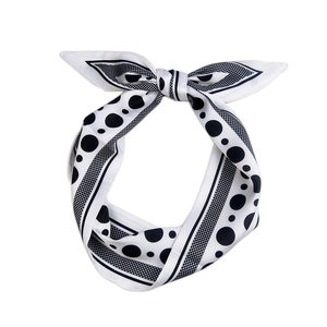 Elegant polka dot silk scarf tied in a bow with black and white satin finish patterns