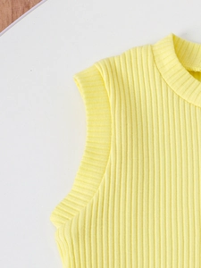 Close-up of bright yellow ribbed knit tank top showing fabric texture and neckline