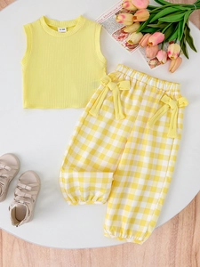 Detail view of toddler girls ribbed yellow tank top and plaid bow trousers outfit set