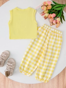 Girl's summer set featuring a yellow ribbed tank top and yellow checkered joggers on display