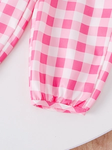 Close-up of elastic cuffs on girls pink and white gingham plaid summer outfit