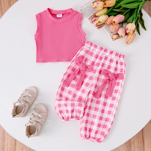 Flat lay of pink ribbed tank top and checkered pants with bow for 6-9 month old girls